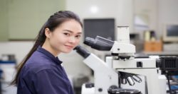 innovation, female scientist looking in microscope in laboratory Laboratory Microscope