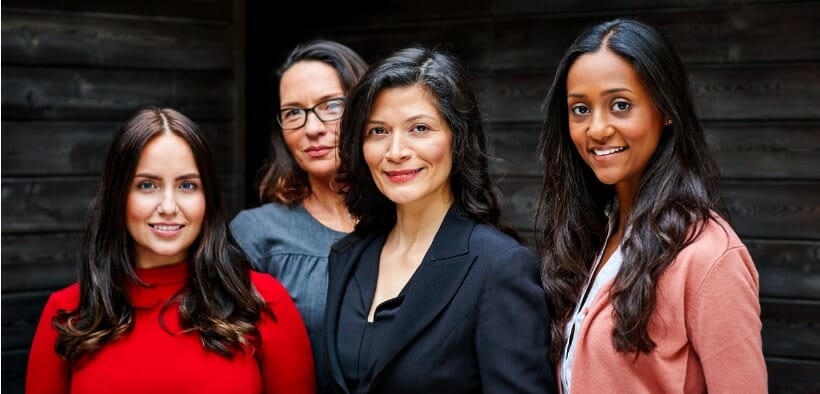 A diverse group of four female leaders in higher ed faces the camera