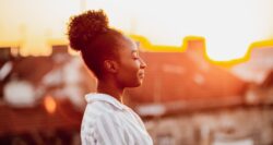 Woman takes a moment to breathe and close her eyes